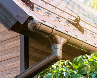 A tiled roof with metal gutter