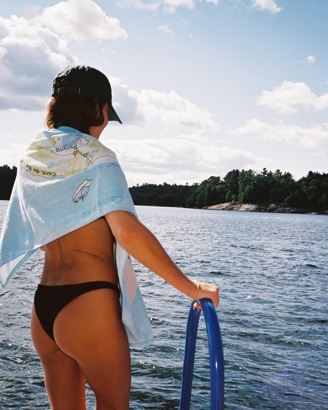 woman wearing black bikini bottoms by lake