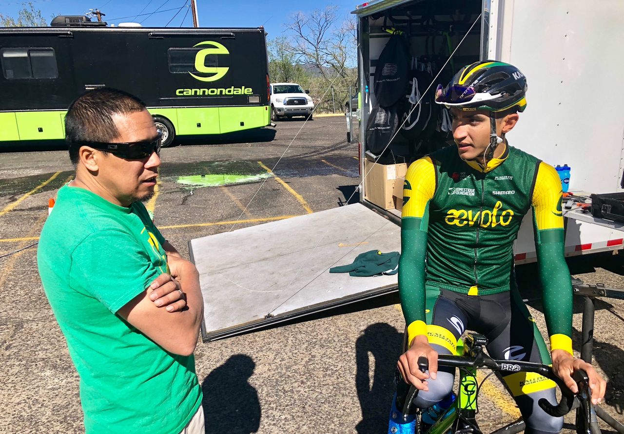 Aevolo mechanic Vincent Gee talks with a rider before the Tour of the Gila criterium