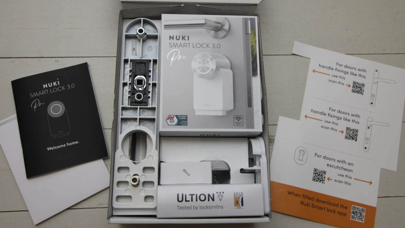 Ultion Nuki Plus unboxing, showing the lock in its packaging with various instruction booklets