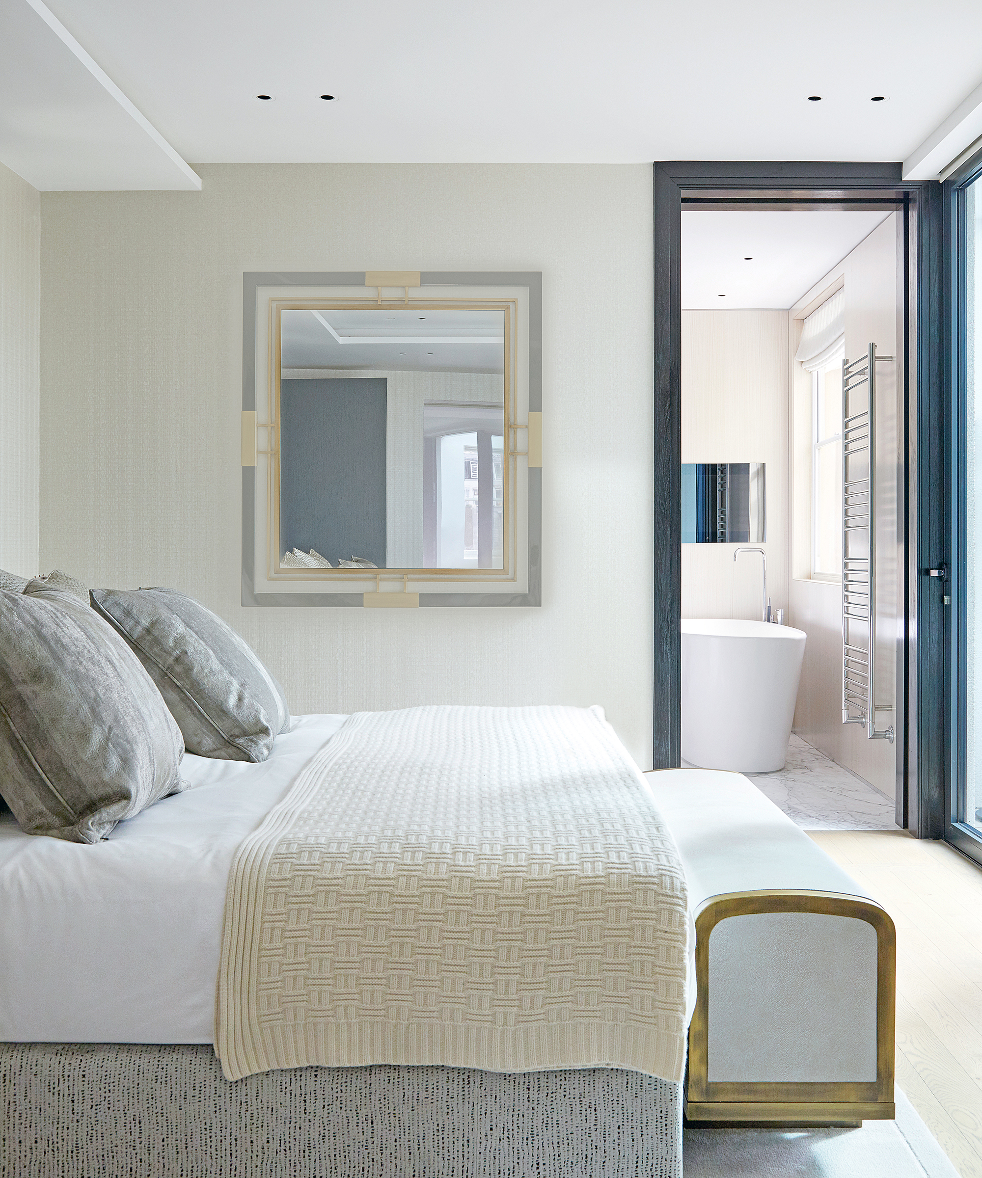 A bedroom TV idea with a television in the en suite of a white bedroom