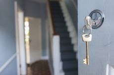 Front door of house with key in lock