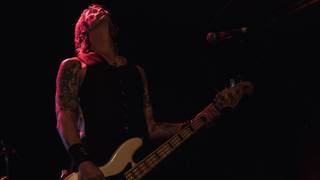 Bassist Duff McKagan of Guns and Roses performs on stage