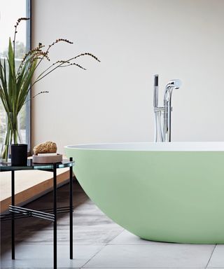 Colorful bathrooms, green freestanding tub