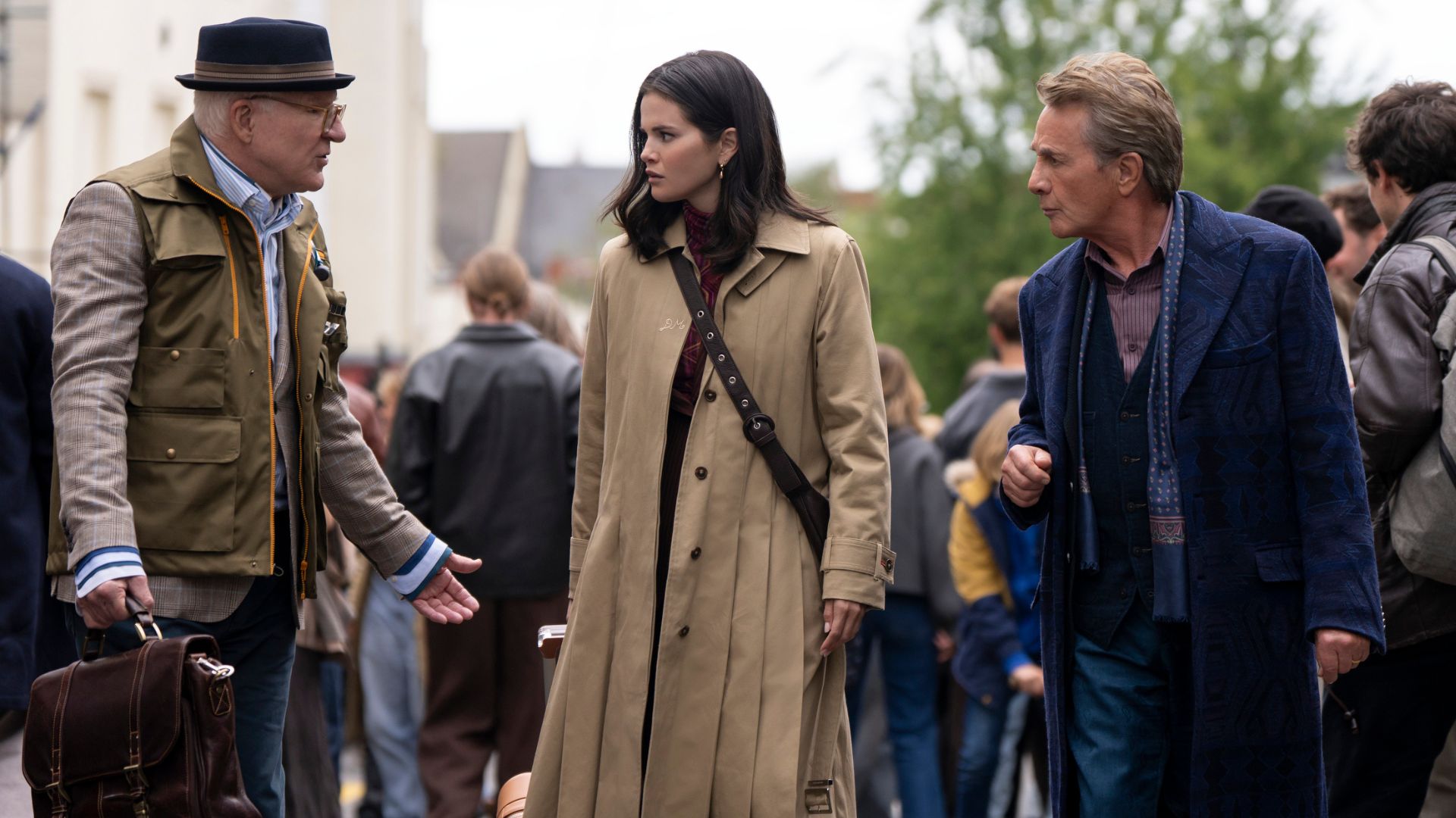 Charles, Mabel and Oliver walk down a busy street