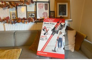Henry Cordless Vacuum in box on Annie's sofa