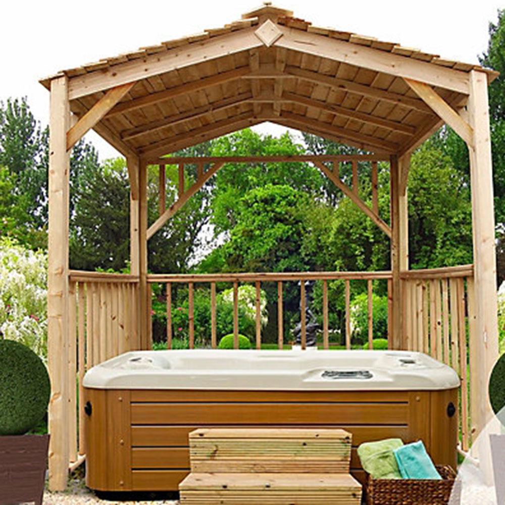 hot tub on a wooden deck covered by a wooden gazebo for privacy and shelter