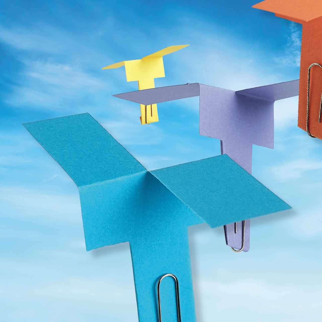 Paper helicopters on a sky image background