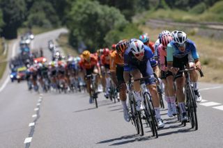 The pack of riders (peloton) cycles during the 18th stage of the 111th edition of the Tour de France cycling race, 179,5 km between Gap and Barcelonnette, in southeastern France, on July 18, 2024. (Photo by Thomas SAMSON / AFP) (Photo by THOMAS SAMSON/AFP via Getty Images)