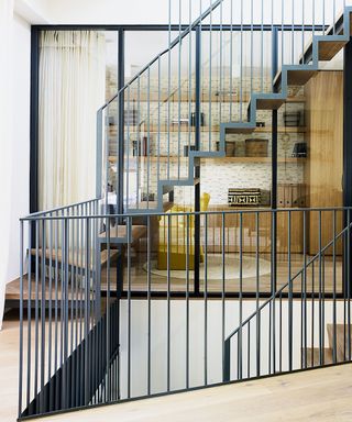 hallway with steel and oak staircase in Victorian mews house in London with contemporary interior designed by Kitesgrove