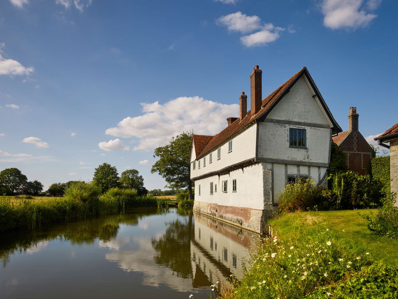 Columbine Hall and moat from south east.