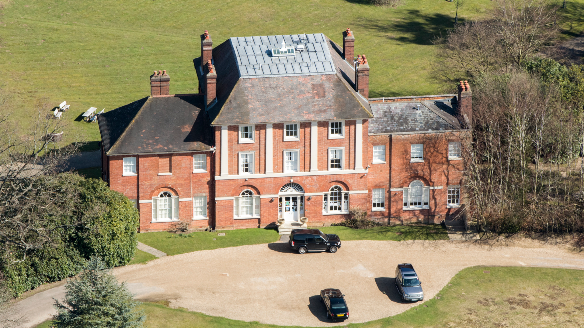 A photo of Forest Lodge with cars in front