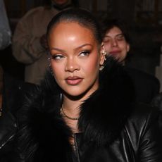 Photo of Rihanna wearing a black jacket at Paris Fashion Week