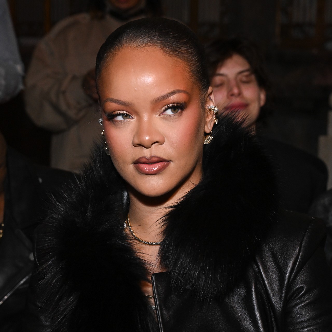 Photo of Rihanna wearing a black jacket at Paris Fashion Week