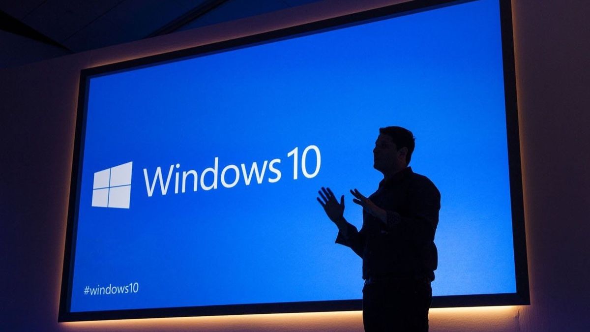 Former Microsoft Executive Vice President Terry Myerson stands in front of a presentation about Windows 10