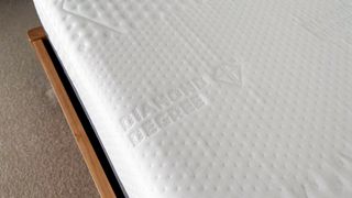 Branding on the mattress cover of the Emma Diamond Hybrid Mattress