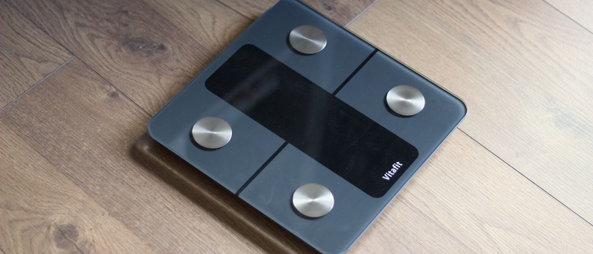 Vitafit smart scale on a wooden floor