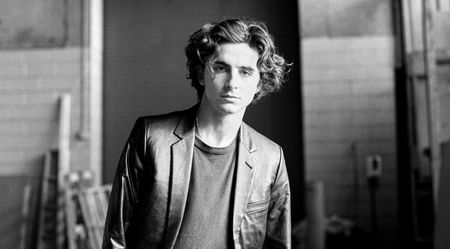 A black and white portrait of Timothée Chalamet in the Bleu de Chanel campaign