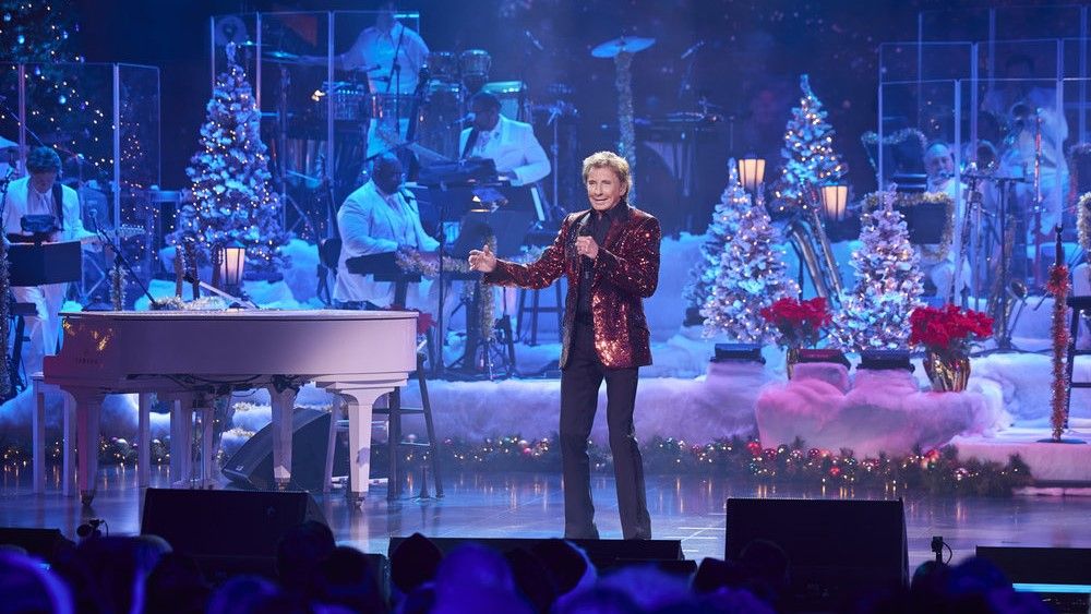 Barry Manilow performs on a holiday stage in Barry Manilow&#039;s A Very Barry Christmas