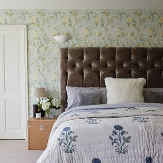 guest bedroom with wallpaper and bedside lamp and b