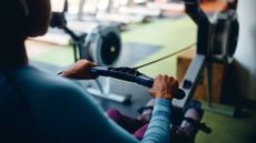 Woman's arms doing rowing machine workout