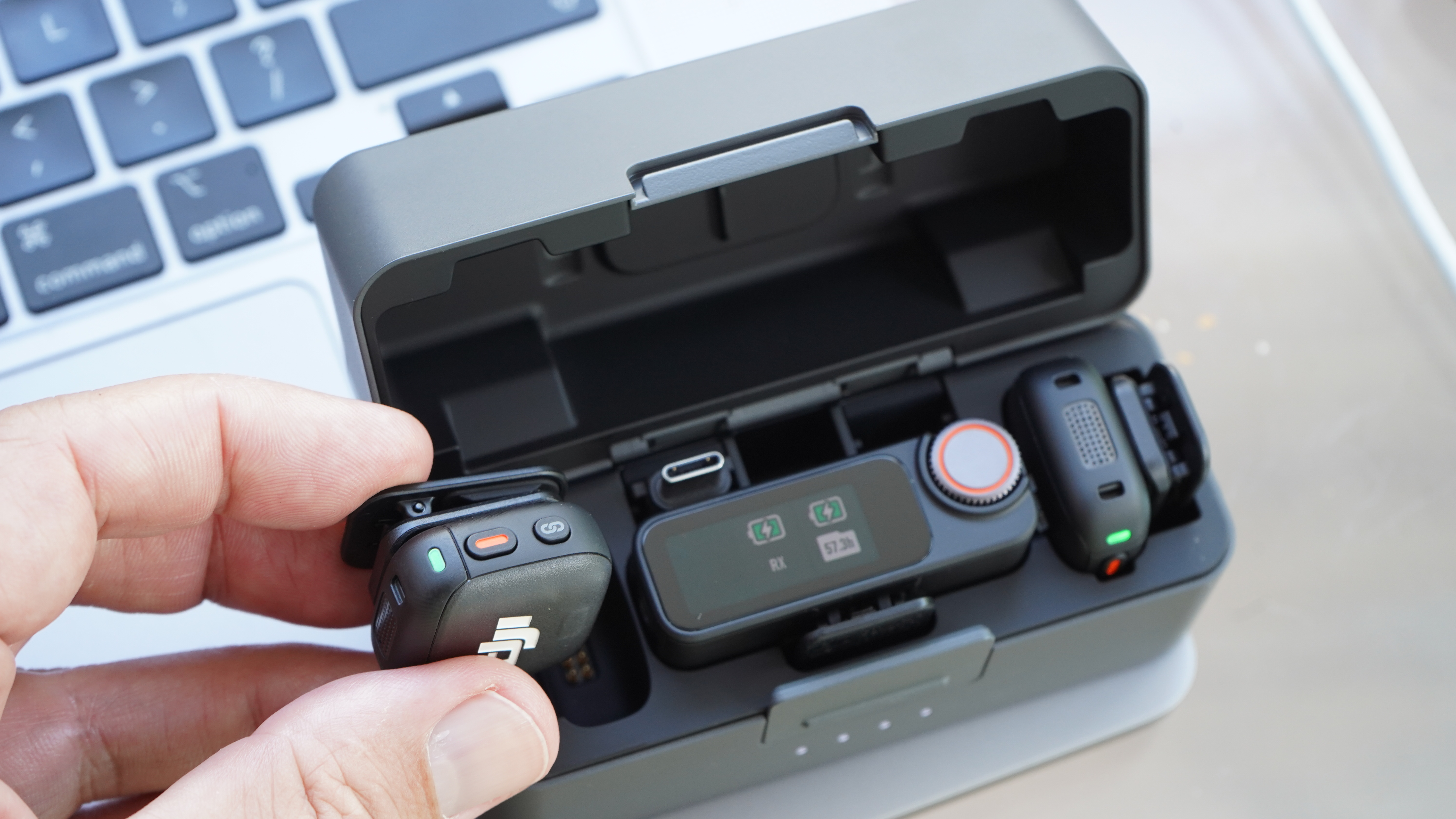 DJI Mic 3 being taken from charging case