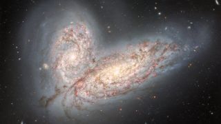 two bright spiral galaxies with mingling stars