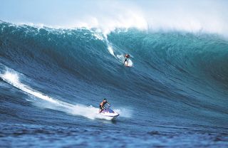 Here, surfer Noah Johnson drops into a 30-foot-high (9 meters) behemoth on the Outer Reefs on Nov. 15, 2000.