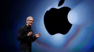 Apple's CEO Tim Cook on stage in front of an Apple logo