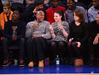 Michelle Trachtenberg and Princess Eugenie sit next to one another at Madison Square Garden on December 14, 2013 to watch the Atlanta Hawks vs New York Knicks