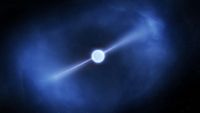 a blue-white cloud surrounds bright white orb from which two jets of white light are extending in opposite directions, on a starry black background