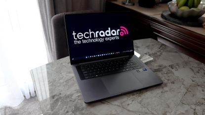 A laptop on a grey worktop surface.