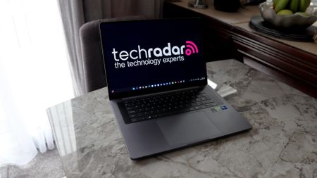 A laptop on a grey worktop surface.