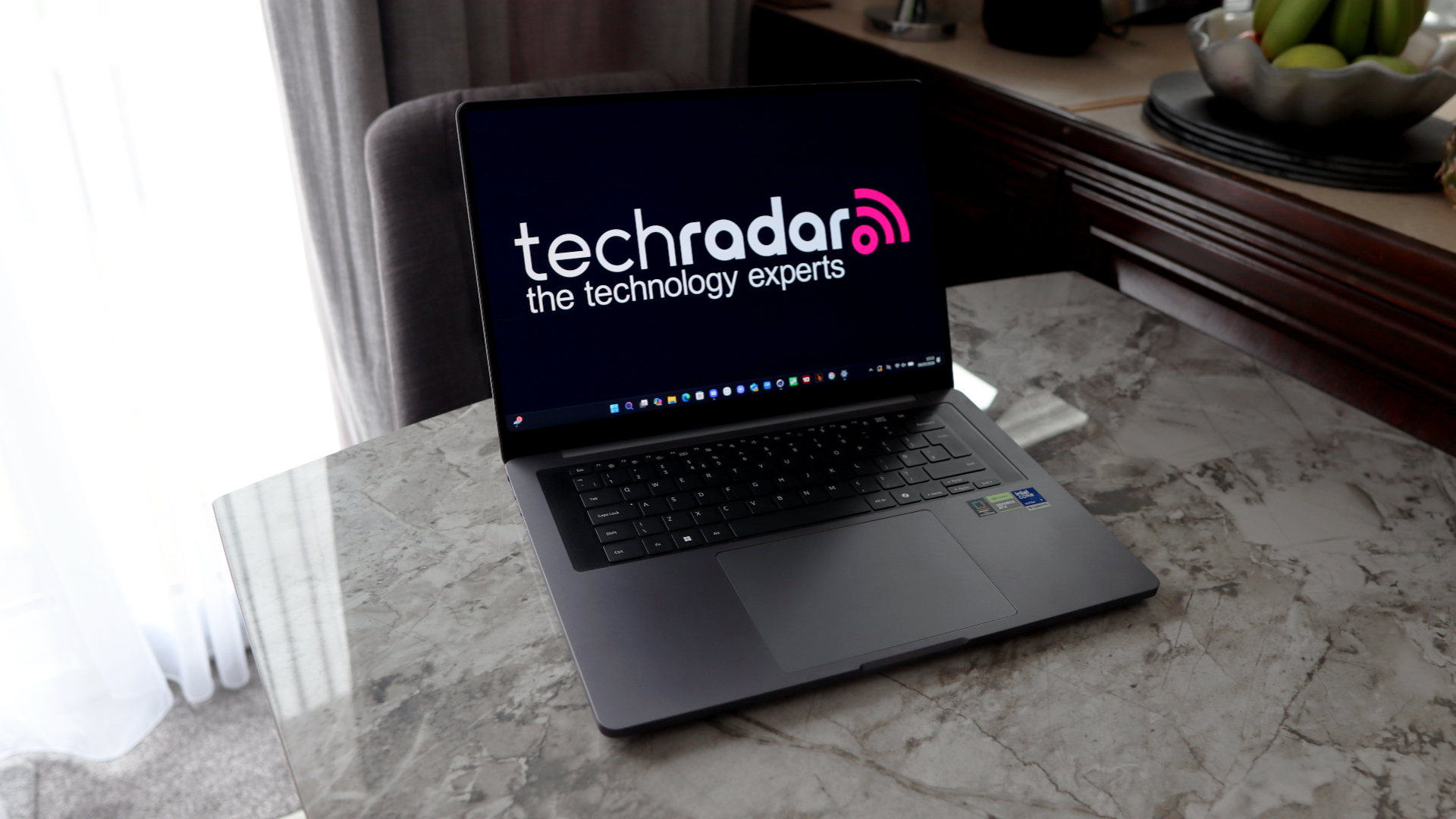 A laptop on a grey worktop surface.