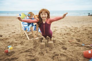 a girl having fun on a beach at a parkdean resort