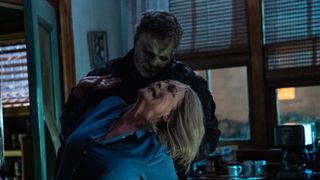 Michael Myers attacking Laurie Strode in a kitchen.