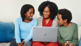 Three people looking at an HP Chromebook