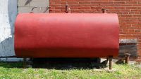 A freshly red painted oil boiler tank