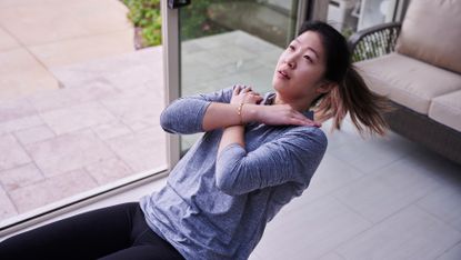 Woman completes an ab workout on the floor