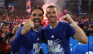 Edin Dzeko (right) and Kenan Karaman of FC Schalke 04 pose for a photo as they celebrate promotion to the Bundesliga