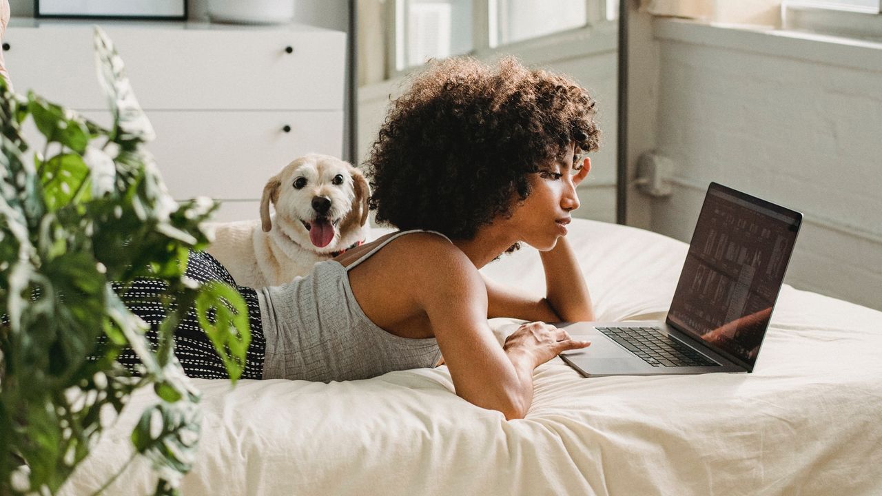 Woman watching YouTube Premium on her bed