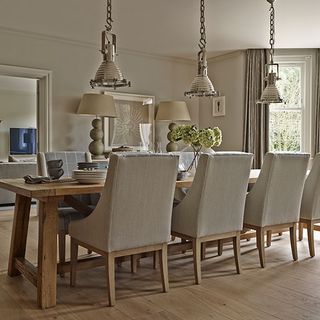 neutral dining room with silver pendant lights