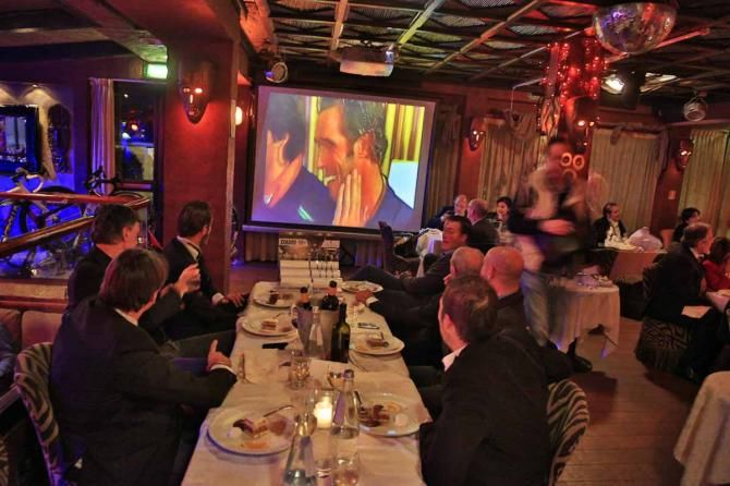 The Zolder team watches a psot-race interview with Cipollini