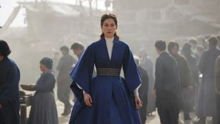 Rosamund Pike in her blue robe as Moiraine Damodred in The Wheel of Time season 2