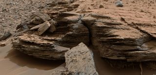 This view from the Mast Camera on NASA's Mars rover Curiosity of "Whale Rock" at the base of Mount Sharp, taken on Nov. 2, 2014, shows an example of cross-bedding that results from water passing over a loose bed of sediment.