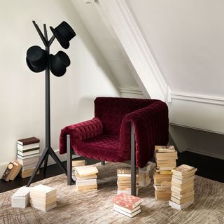 assymetrical velvet chair on designed floor
