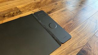The Journey ALTI Wireless charging desk mat in a wood-lined office