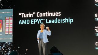 Lisa Su, CEO at AMD, live onstage at AMD Advancing AI in San Francisco, holding a n AMD chip.