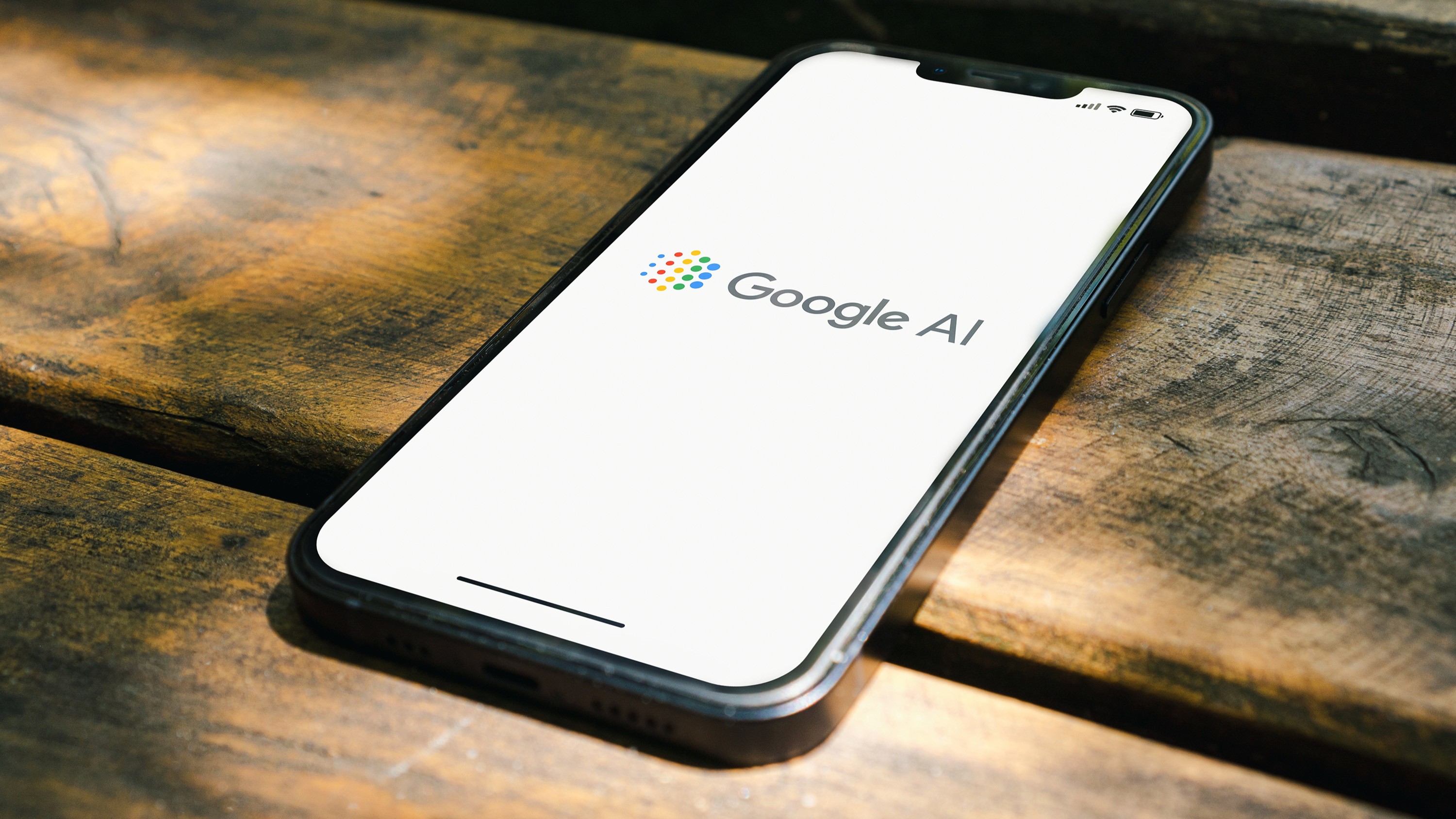The Google AI logo on a smartphone on a table