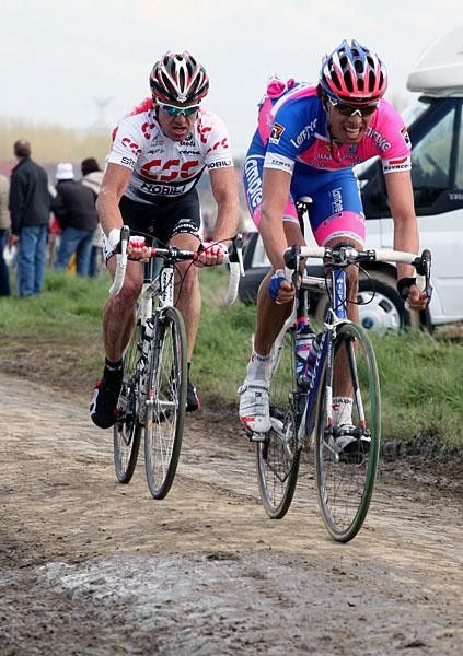 Alessandro Ballan in an earlier part of the race with O'Grady carrying bottles.